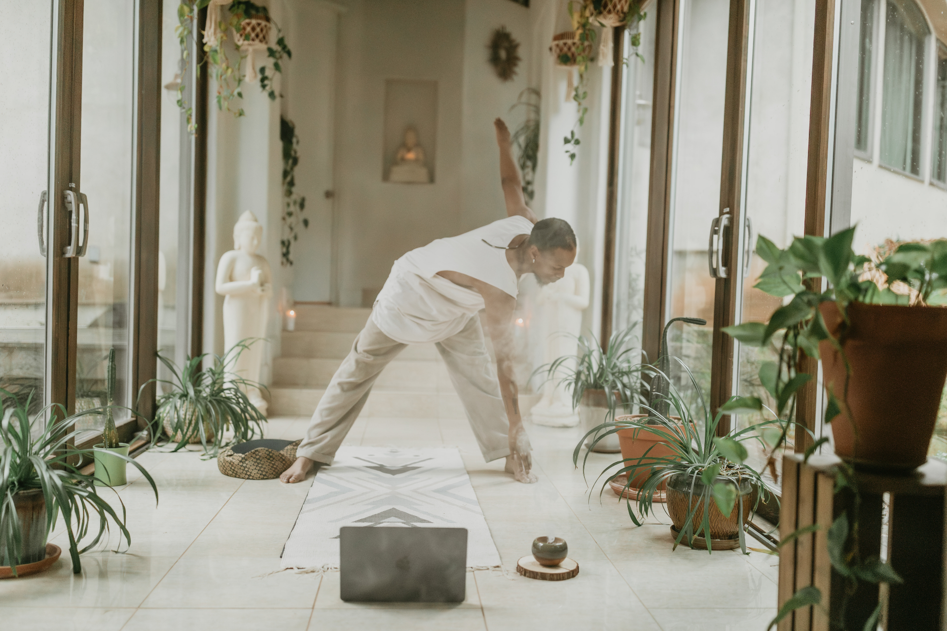Home yoga practice space with laptop